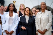 VP Kamala Harris poses with attendees during an NCAA championship teams celebration on the South Lawn of the White House.