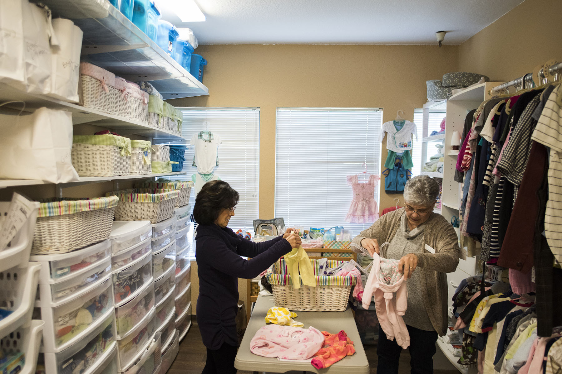 Volunteers organize baby clothes at an anti-abortion center in California.