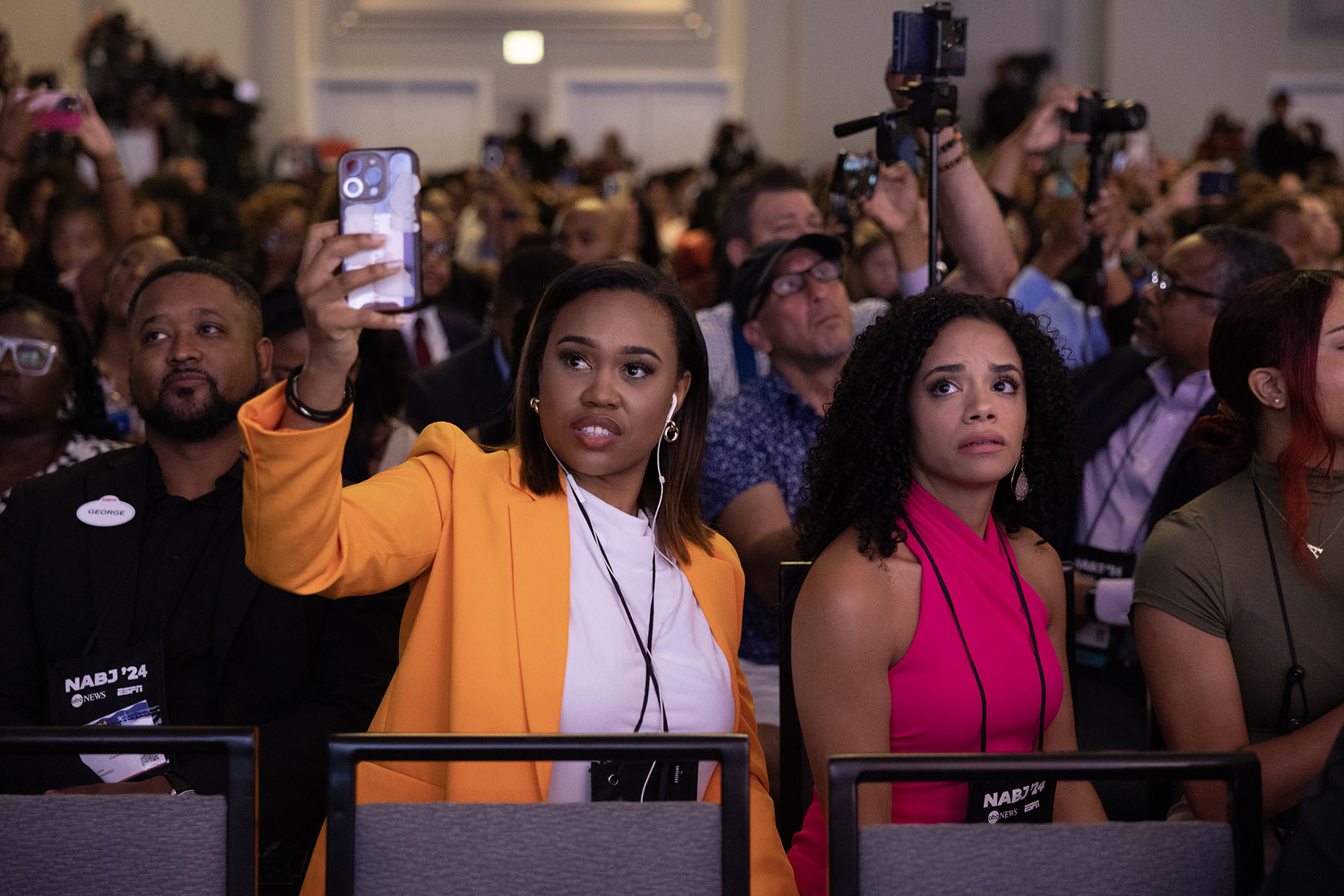 Guests react as Donald Trump participates in a Q&A session at the National Association of Black Journalists' yearly convention.