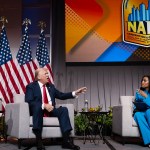 Former President Donald Trump speaks with ABC journalist Rachel Scott on stage at the National Association of Black Journalists convention's yearly convention.