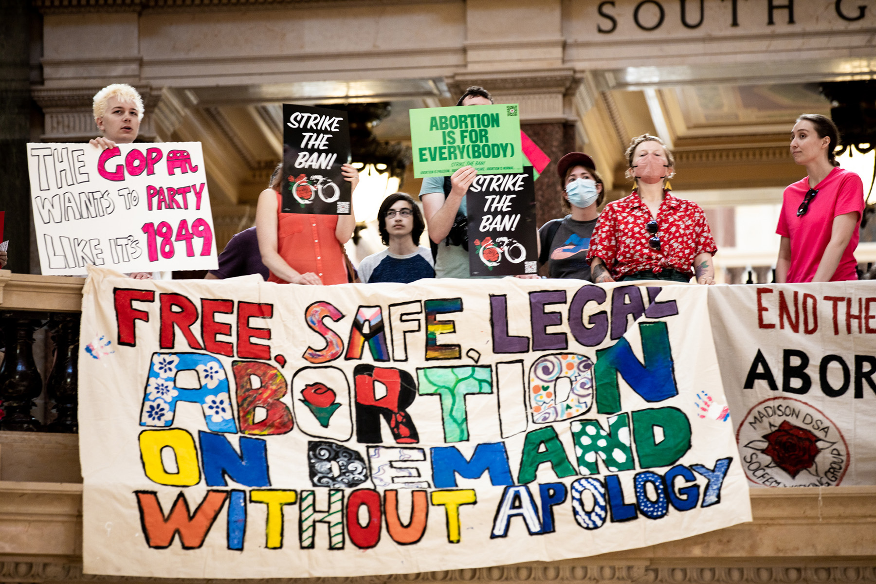 Planned Parenthood advocates protest at the Wisconsin State Capitol. Signs read "the GOP wants to party like its 1849," "Free, safe, legal abortion on demand without apology," "strike the ban" and "abortion is for every(body)."