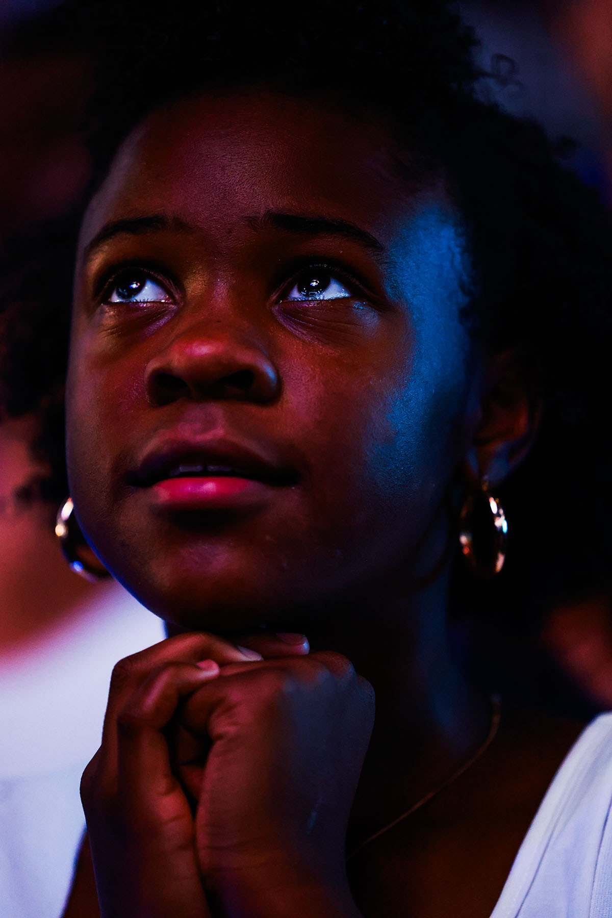 Tyla'Grace Edgecomb, 10, watches the DNC Roll Call as she awaits the arrival of Vice President Kamala Harris and Minnesota Gov. Tim Walz at a campaign stop.