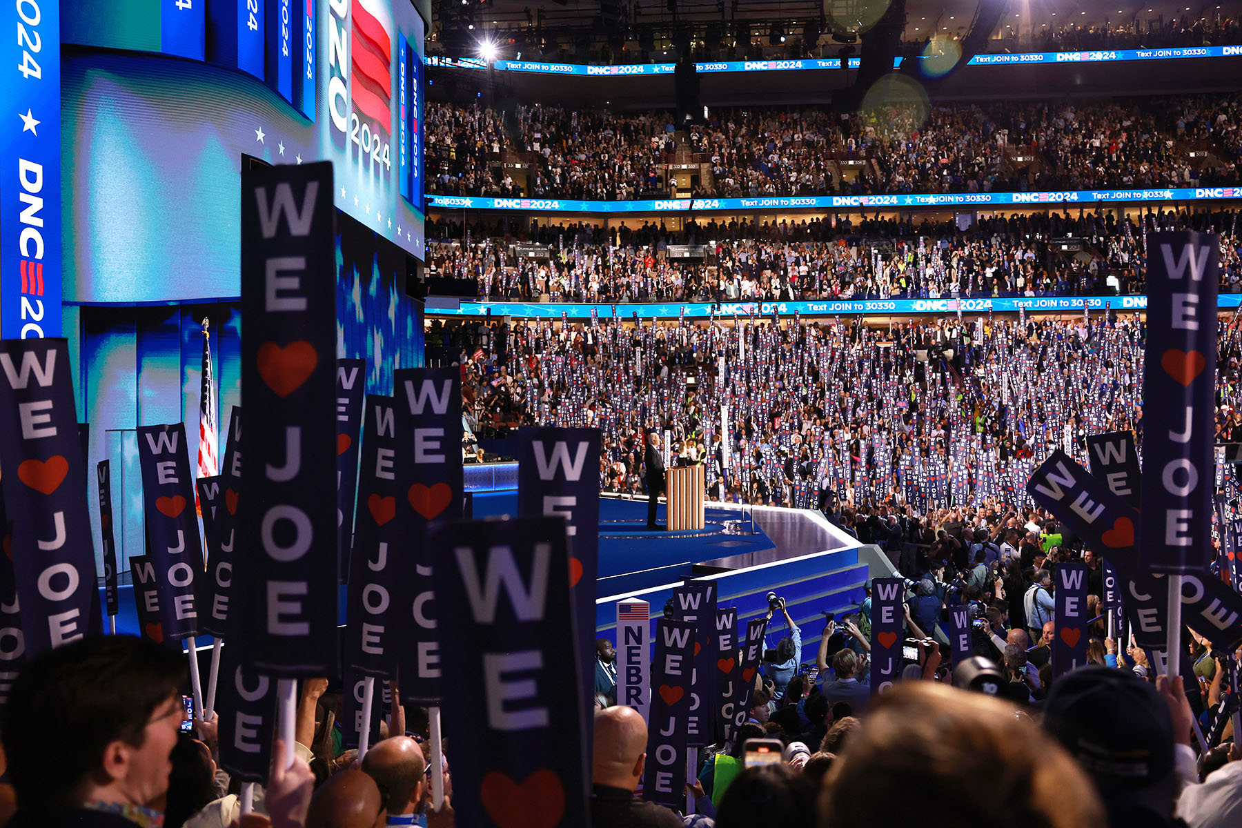 President Biden speaks onstage during the first day of the DNC.