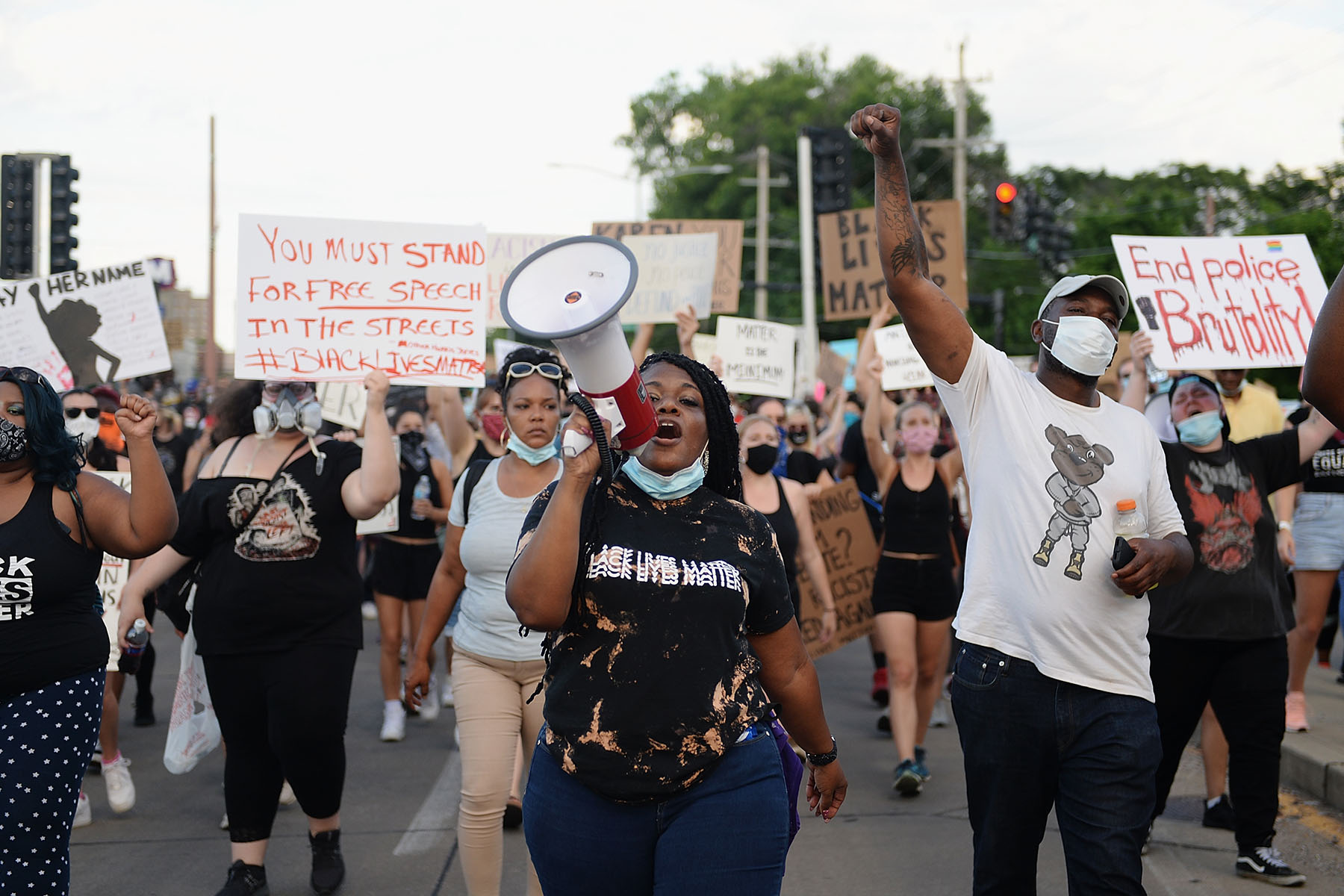 Cori Bush chants into a megaphone as she leads demonstrators as they take to the street to protest against police brutality.