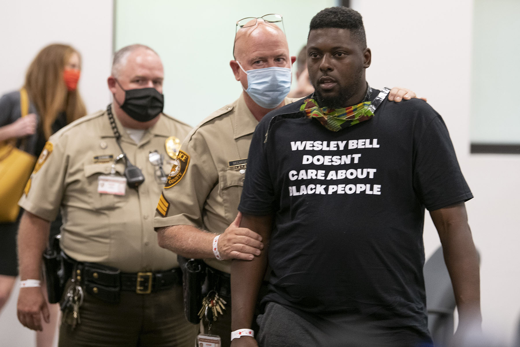 An objector wearing a "Wesley Bell doesn't care about black people shirt" interrupts the end of a press conference after Wesley Bell announced no charges against former Ferguson police officer Darren Wilson for shooting and killing Michael Brown Jr.