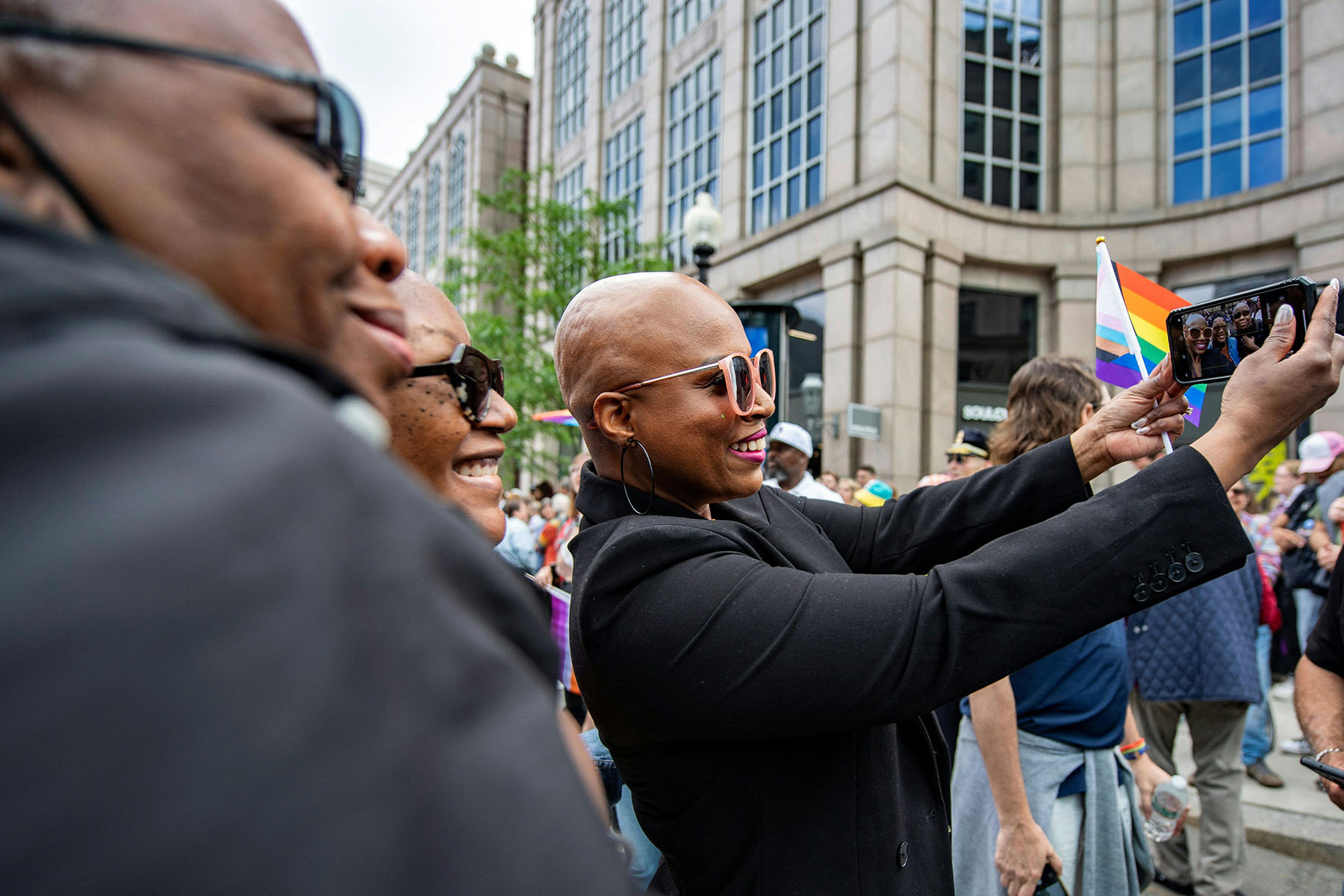 Ayanna Pressley takes a seflie with attendees at the Boston pride parade.