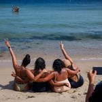 Friends pose for a photo while relaxing on Oak Bluffs Town Beach in Martha's Vineyard, Massachusetts.