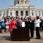 Gov. Tim Walz is seen at a ceremonial budget bill-signing party on the Minnesota State Capitol steps.