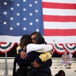 Three supporters in a group hug following Vice President Kamala Harris' speech at Howard University in Washington, D.C.