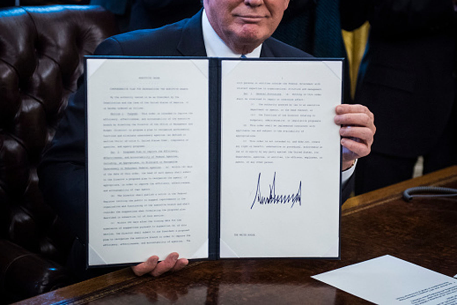 Trump holding an evil executive order.