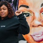 Tamika Palmer, mother of Breonna Taylor, poses for a portrait in front of a mural of her daughter at Jefferson Square park in Louisville, Kentucky.