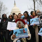HIV advocates demonstrate to oppose federal HIV funding cuts in front of the Capitol.