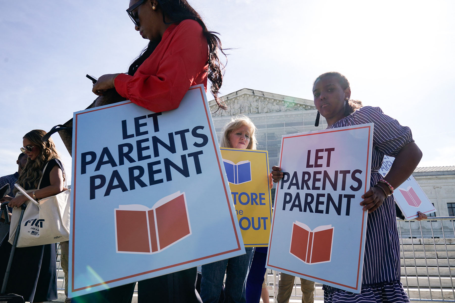 People supporting the right to opt-out their children from classes containing LGBTQ-related content demonstrate outside the Supreme Court.
