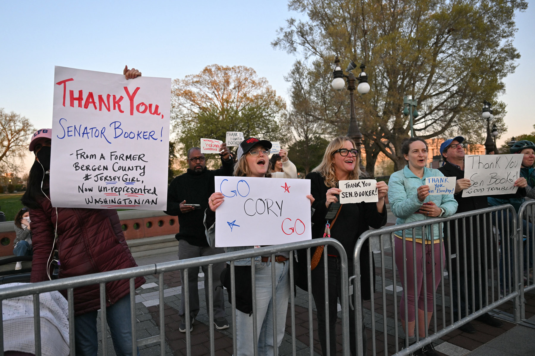 Supporters raise signs thanking Senator Cory Booker.