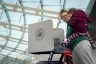 A women holds her daughter as she fills out her ballot at a polling site.