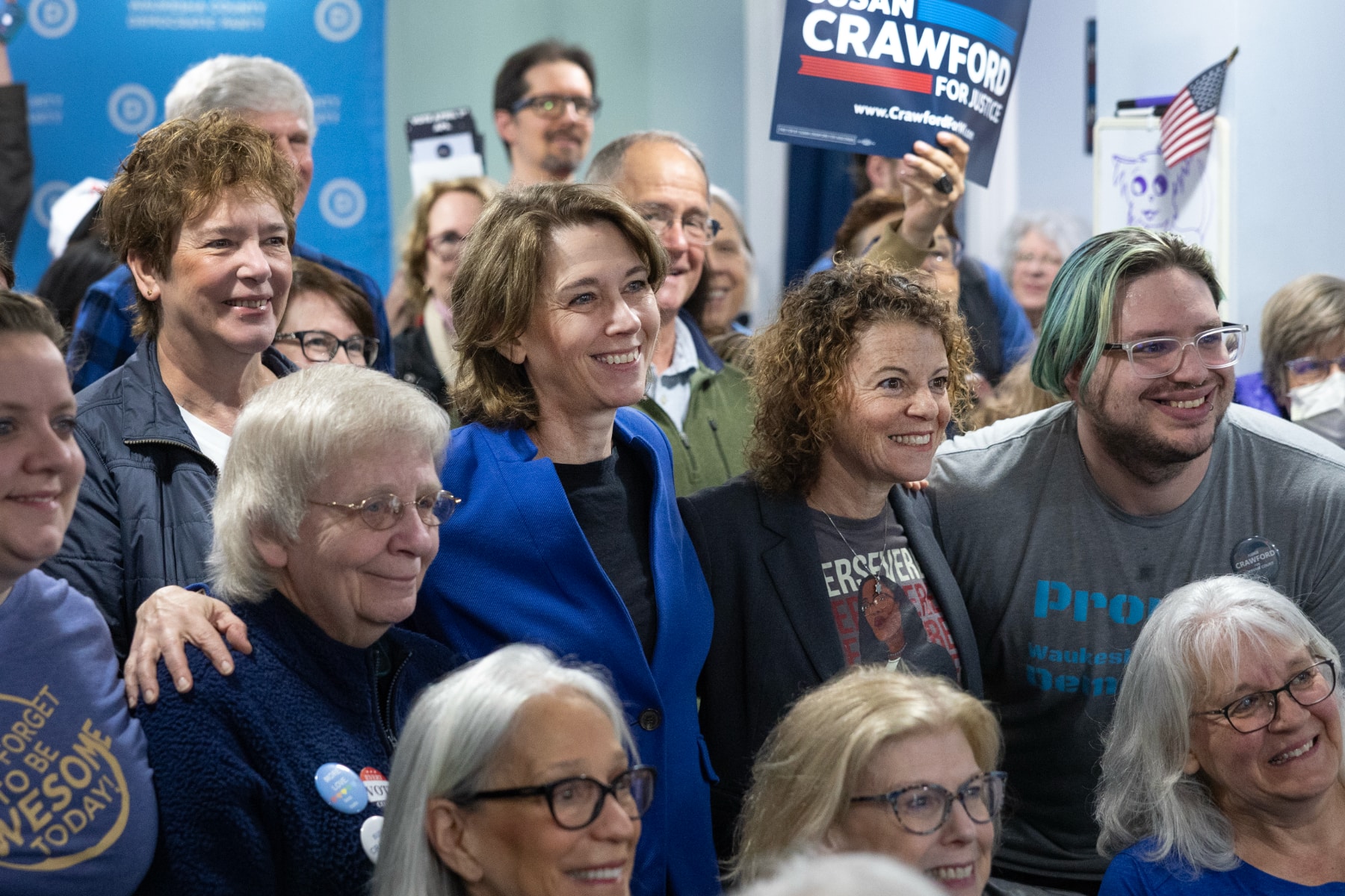Judge Susan Crawford, wearing a blue jacket, stands with supporters
