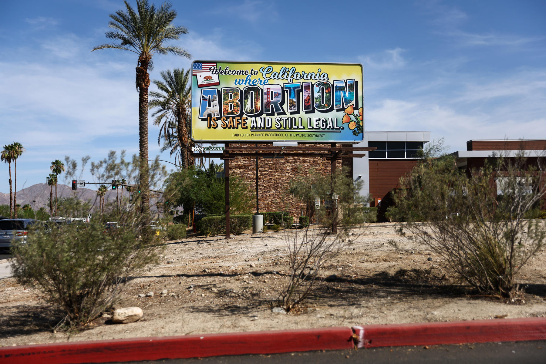 A billboard reads, "Welcome to California where abortion is safe and still legal."