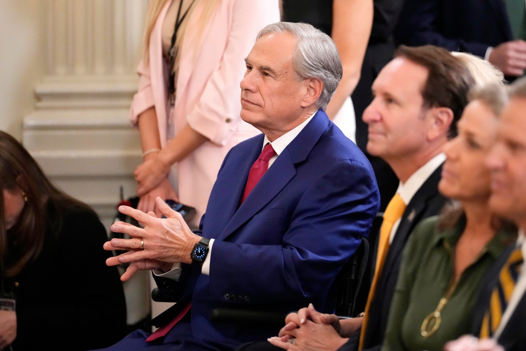 Texas Gov. Greg Abbott sits before President Donald Trump arrives to speak at the White House.