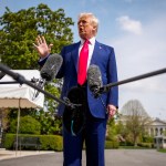 President Donald Trump speaks to members of the media before boarding Marine One on the South Lawn of the White House.