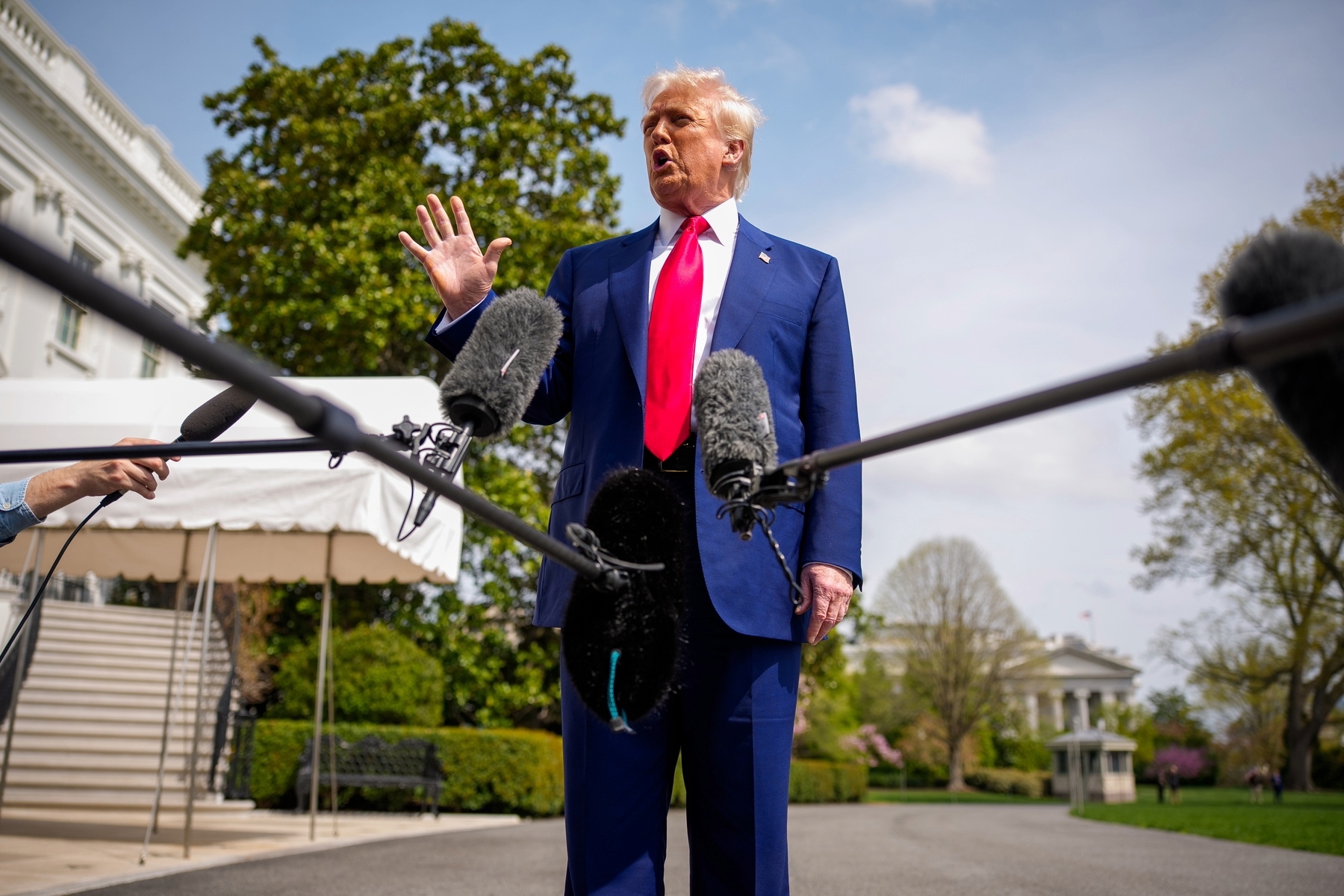 President Donald Trump speaks to members of the media before boarding Marine One on the South Lawn of the White House.