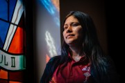 Ruano stands near a stained glass window inside her Milwaukee church.