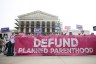 Anti-abortion protestors gather outside the Supreme Court holding a banner that reads 
