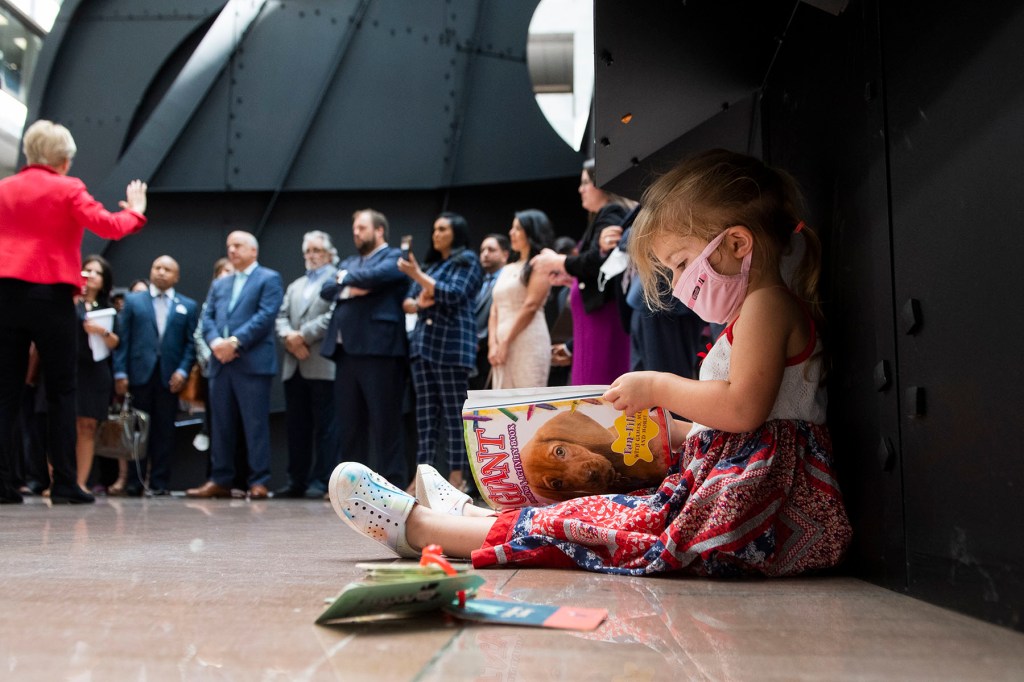 Lark, the daughter of Rep. Erin Zwiener colors in the Hart Senate Office Building.